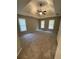 Expansive main bedroom with tray ceilings, plush carpeting, and multiple windows for ample natural light at 1915 Habersham Trce, Cumming, GA 30041