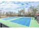 Community tennis courts with two well-maintained, lighted courts, and a small seating area at 1915 Habersham Trce, Cumming, GA 30041