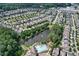 An aerial shot shows a community pond and pool surrounded by neatly arranged homes and lush greenery at 2013 White Cypress Ct, Smyrna, GA 30082