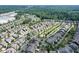An aerial shot shows a community pond and pool surrounded by neatly arranged homes and lush greenery at 2013 White Cypress Ct, Smyrna, GA 30082