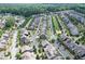 Aerial view showcasing a residential community nestled within a verdant landscape near a pond at 2013 White Cypress Ct, Smyrna, GA 30082