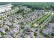 An aerial view showcases a well-planned community with tree-lined streets, green spaces, and a central pond at 2013 White Cypress Ct, Smyrna, GA 30082