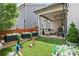 Backyard features artificial turf, planting beds, covered patio and playful backyard games at 2013 White Cypress Ct, Smyrna, GA 30082