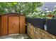 The backyard features a shed, planting beds and a stone retaining wall at 2013 White Cypress Ct, Smyrna, GA 30082