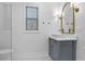 Elegant bathroom with a grey vanity, white countertops, gold fixtures, and stylish mirror and lighting at 2013 White Cypress Ct, Smyrna, GA 30082