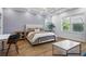 Inviting bedroom with a tray ceiling, board and batten wall, and ample natural light at 2013 White Cypress Ct, Smyrna, GA 30082