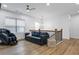 Spacious bonus room with a sofa bed, massage chair, and wood floors at 2013 White Cypress Ct, Smyrna, GA 30082
