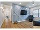 Stylish bonus room with custom wall paneling, TV, massage chair, and wood floors at 2013 White Cypress Ct, Smyrna, GA 30082