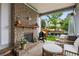 Covered patio boasts brick fireplace, grill, comfortable seating, and overlooks the backyard at 2013 White Cypress Ct, Smyrna, GA 30082