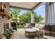 Covered patio offers comfortable seating with an outdoor fireplace and backyard views at 2013 White Cypress Ct, Smyrna, GA 30082