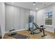 Exercise room featuring wood-look floors, recessed lighting, paneled accent wall and large window at 2013 White Cypress Ct, Smyrna, GA 30082