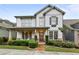 Charming two-story home with a covered front porch, landscaped yard, and a combination of siding and stone accents at 2013 White Cypress Ct, Smyrna, GA 30082
