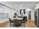 Modern kitchen with custom cabinets, stainless steel appliances, an island, and an adjacent dining area at 2013 White Cypress Ct, Smyrna, GA 30082