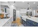 This spacious kitchen features a large island, stainless steel appliances, marble countertops and custom cabinetry at 2013 White Cypress Ct, Smyrna, GA 30082