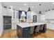 Bright kitchen with marble countertops, a large center island with barstool seating, and stainless steel appliances at 2013 White Cypress Ct, Smyrna, GA 30082