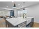 This modern kitchen features a large island with a sink, stainless steel appliances, and a cozy dining area at 2013 White Cypress Ct, Smyrna, GA 30082