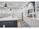 Open-concept kitchen with an island, stainless steel appliances, and large windows for plenty of natural light at 2013 White Cypress Ct, Smyrna, GA 30082