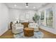 Cozy living room with neutral tones, natural light, stylish furnishings, and a view of the landscaped exterior at 2013 White Cypress Ct, Smyrna, GA 30082