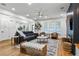 Spacious open-concept living room flowing into the kitchen, featuring hardwood floors and stylish decor at 2013 White Cypress Ct, Smyrna, GA 30082