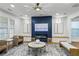 Stylish living room with a navy accent wall, fireplace, modern lighting, and comfortable seating arrangements at 2013 White Cypress Ct, Smyrna, GA 30082