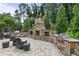 Outdoor stone kitchen area with built-in grill and bar seating, perfect for outdoor entertaining and BBQs at 2013 White Cypress Ct, Smyrna, GA 30082