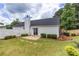 Backyard with a small patio, fence, and well-maintained lawn surrounded by greenery at 214 Chelsea Ct, Woodstock, GA 30189