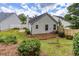 Spacious backyard with green grass, tidy landscaping, and a charming white fence at 214 Chelsea Ct, Woodstock, GA 30189