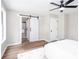 Spacious bedroom with plank floors, ceiling fan, and access to the ensuite bathroom at 214 Chelsea Ct, Woodstock, GA 30189