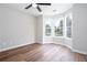 Bright bedroom with bay windows that provide natural light, complemented by wood plank flooring at 214 Chelsea Ct, Woodstock, GA 30189