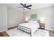 Inviting bedroom with a ceiling fan, neutral walls, and plank floors at 214 Chelsea Ct, Woodstock, GA 30189