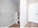Walk-in closet includes adjustable shelving and plenty of storage space at 214 Chelsea Ct, Woodstock, GA 30189