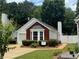 Exterior showing home with red brick accent wall, bay window, and manicured landscaping at 214 Chelsea Ct, Woodstock, GA 30189