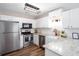 Modern kitchen with stainless steel appliances, white cabinets, and a stylish farmhouse sink at 214 Chelsea Ct, Woodstock, GA 30189