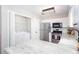 Well-lit kitchen featuring stainless steel appliances, granite countertops, and convenient washer/dryer closet at 214 Chelsea Ct, Woodstock, GA 30189