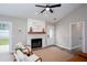 Living room featuring a fireplace, neutral colors, and access to the backyard at 214 Chelsea Ct, Woodstock, GA 30189