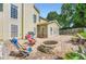 Large backyard featuring a brick surround, fire pit, and chairs at 1713 Paramore Ne, Marietta, GA 30062