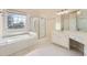 Bright bathroom featuring a soaking tub, glass shower, and white marble countertops at 1713 Paramore Ne, Marietta, GA 30062