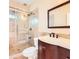 Bathroom featuring a glass-enclosed shower, marble-look tiling, dark wood vanity, and modern fixtures at 1713 Paramore Ne, Marietta, GA 30062