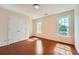 Well-lit bedroom featuring a hardwood floor, double door closet, and two windows at 1713 Paramore Ne, Marietta, GA 30062