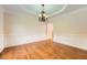 Dining room featuring hardwood floors, crown molding, and a stylish chandelier at 1713 Paramore Ne, Marietta, GA 30062