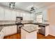 Bright kitchen with white cabinetry, granite countertops, stainless steel appliances, and hardwood floors at 1713 Paramore Ne, Marietta, GA 30062