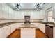 Bright kitchen with white cabinetry, granite countertops, stainless steel appliances, and hardwood floors at 1713 Paramore Ne, Marietta, GA 30062