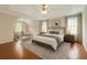 Spacious main bedroom with tray ceilings, hardwood floors, neutral decor, and stylish furniture at 1713 Paramore Ne, Marietta, GA 30062