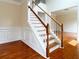 Elegant staircase with wood treads, white risers and trim, and decorative wainscoting at 1713 Paramore Ne, Marietta, GA 30062
