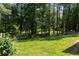 Spacious backyard featuring a well-maintained lawn, mature trees, and an enclosed area at 2050 Lyda Ln, Loganville, GA 30052