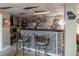 Stylish basement bar with tiled facade, bar stool seating, and decorative sports memorabilia at 2050 Lyda Ln, Loganville, GA 30052