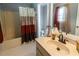 Bathroom featuring a tub-shower combo, vanity with storage, and neutral color palette at 2050 Lyda Ln, Loganville, GA 30052