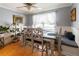 Cozy dining nook featuring built-in bench seating, rustic table, and ample natural light from the large window at 2050 Lyda Ln, Loganville, GA 30052