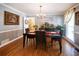 Elegant dining room with hardwood floors, chandelier lighting, decorative accents, and large window at 2050 Lyda Ln, Loganville, GA 30052