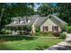 Charming home with a welcoming front porch, well-manicured lawn, and vibrant landscaping at 2050 Lyda Ln, Loganville, GA 30052